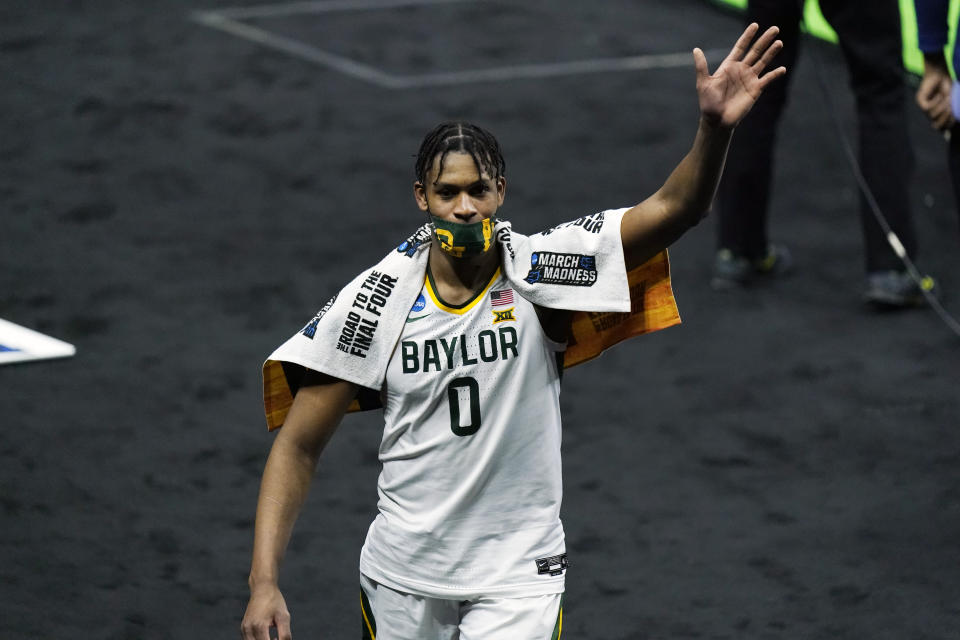 Baylor's Flo Thamba waves to fans as he leaves the court after Baylor defeated Hartford in the first round of the NCAA tournament. (AP Photo/Mark Humphrey)