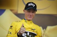 Team Sky rider Chris Froome of Britain, race leader's yellow jersey, reacts on the podium of the 195-km (121.16 miles) 12th stage of the 102nd Tour de France cycling race from Lannemezan to Plateau de Beille, in the French Pyrenees mountains, France, July 16, 2015. REUTERS/Benoit Tessier