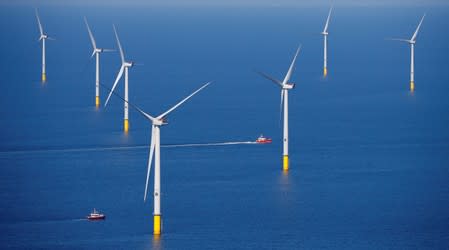 FILE PHOTO: A support vessel is seen next to a wind turbine at the Walney Extension offshore wind farm operated by Orsted off the coast of Blackpool