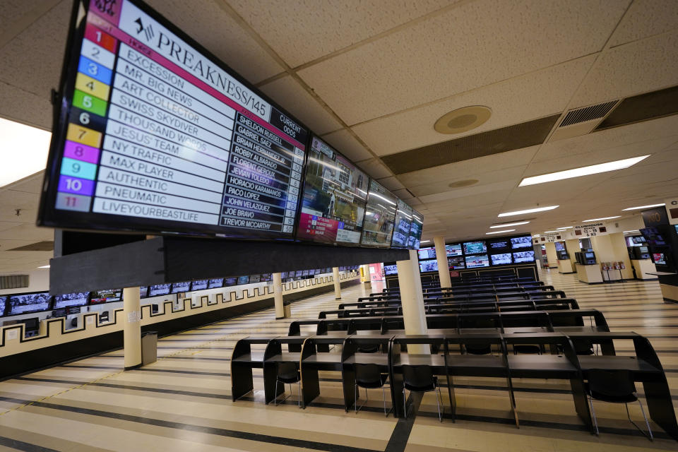 FILE - In this Oct. 2, 2020, file photo, betting tables are empty at Pimlico Race Course in Baltimore. Pimlico, which opened in 1870, is set to be rebuilt over the next two-plus years. (AP Photo/Steve Helber, File)