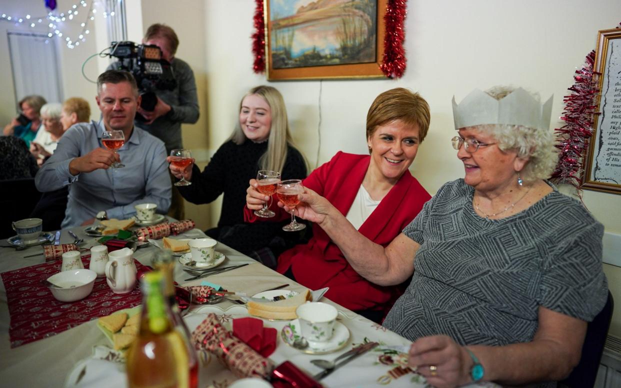 Nicola Sturgeon attends a Christmas dinner at a care home last year - Jeff J Mitchell/Getty