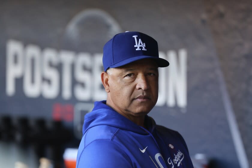 Los Angeles Dodgers manager Dave Roberts stands in the dugout