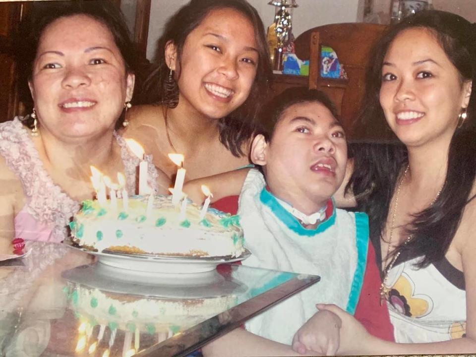 From left to right are mom Julie Nguyen, daughter Jennifer Pham, son Justin Nguyen and daughter Jessica Pham, celebrating Justin’s 12th birthday. Because of the responsibility of helping raise their brother, Jennifer and Jessica barely experienced a childhood.