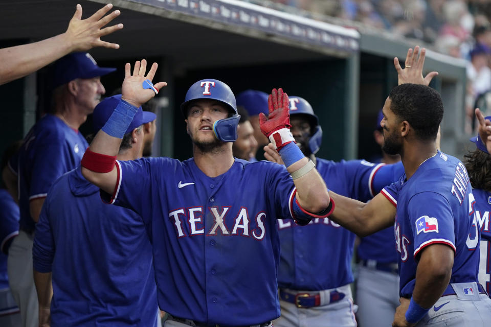 Texas Rangers' Josh Jung is greeted in the dugout after his two-run home run during the seventh inning of a baseball game against the Detroit Tigers, Tuesday, May 30, 2023, in Detroit. (AP Photo/Carlos Osorio)