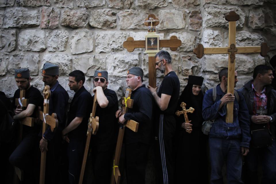 Christian worshippers hold crosses as they wait before the start of a procession along the Via Dolorosa on Good Friday during Holy Week in Jerusalem's Old City April 18, 2014. Christian worshippers on Friday retraced the route Jesus took along Via Dolorosa to his crucifixion in the Church of the Holy Sepulchre. Holy Week is celebrated in many Christian traditions during the week before Easter.