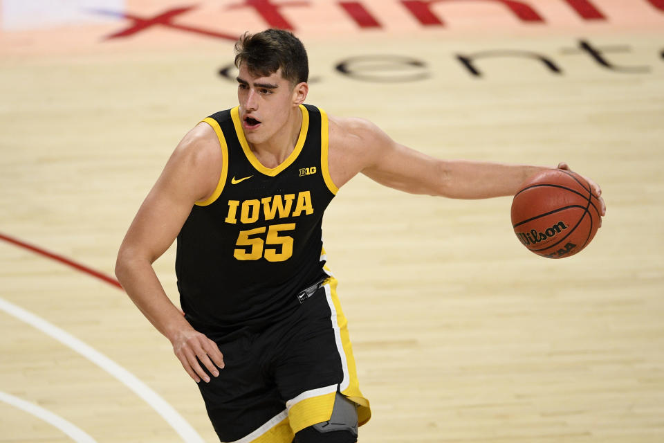 Iowa center Luka Garza (55) dribbles during the first half of an NCAA college basketball game against Maryland, Thursday, Jan. 7, 2021, in College Park, Md. (AP Photo/Nick Wass)