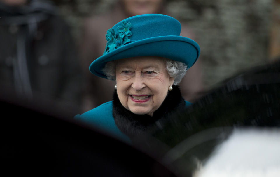 Britain's Queen Elizabeth II walks to get in her car after attending the British royal family's traditional Christmas Day church service in Sandringham, England, Tuesday, Dec. 25, 2012. (AP Photo/Matt Dunham)