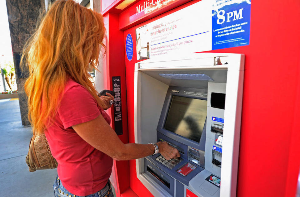 woman using bank ATM