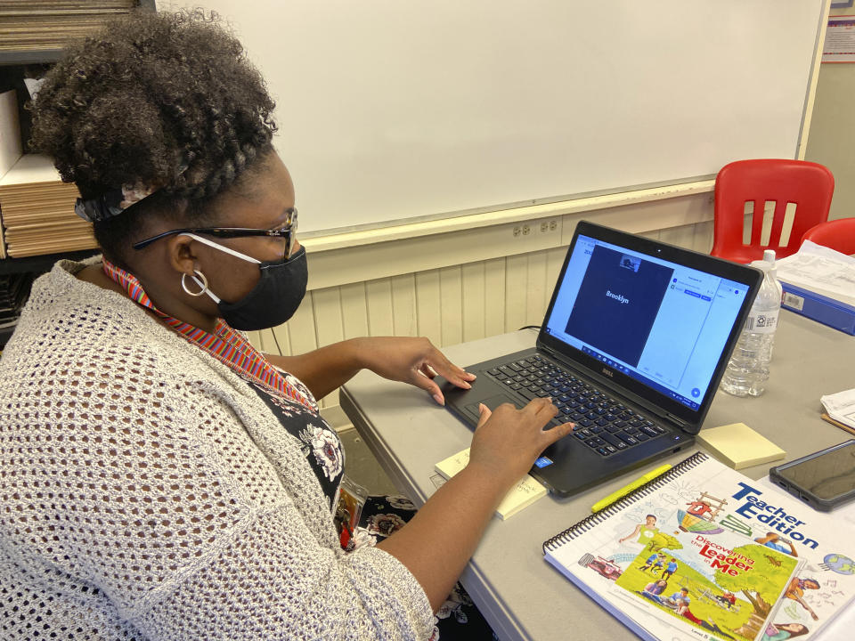 Fifth grade math teacher Jymeka Johnson logs into a Zoom session at Poplar Springs Elementary School in Meridian, Miss., Monday, Aug. 10, 2020. Schools are reopening this week under new guidelines after being closed in March as the COVID-19 pandemic spread. Meridian Public School District students are starting the year using online learning, with plans to return to campus in September. (Bill Graham/The Meridian Star via AP)