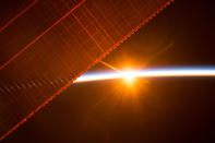 <p>A photo taken on July 26, 2017 by a member of the Expedition 52 crew aboard the International Space Station shows one of the 16 sunrises they experience every day while orbiting Earth. One of the solar panels that provides power to the station is seen in the upper left. (Photo: NASA/Handout via Reuters) </p>