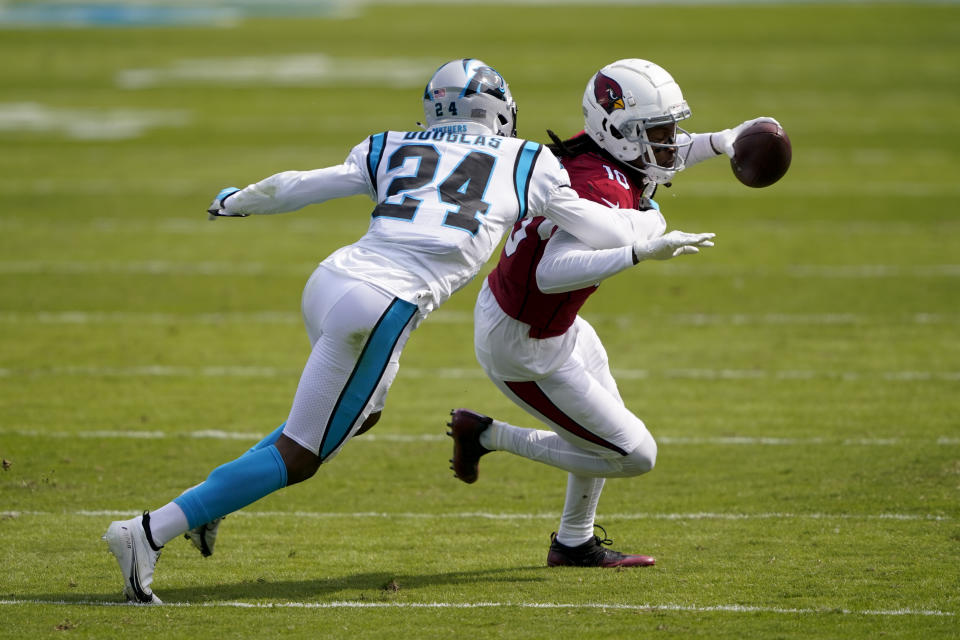 Arizona Cardinals wide receiver DeAndre Hopkins is tackled by Carolina Panthers cornerback Rasul Douglas during the first half of an NFL football game Sunday, Oct. 4, 2020, in Charlotte, N.C. (AP Photo/Brian Blanco)