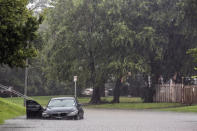 Car gets stuck in a pocket of flood water at Ennis St. at N MacGregor Way near Brays Bayou during Tropical Storm Beta, Tuesday, Sept. 22, 2020, in Houston. Beta has weakened to a tropical depression as it parked itself over the Texas coast, raising concerns of extensive flooding in Houston and areas further inland. (Marie D. De Jesus/Houston Chronicle via AP)