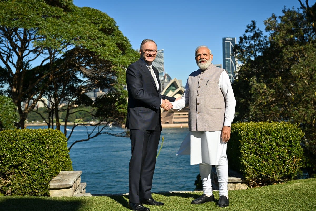 India's Prime Minister Narendra Modi (R) shakes hands with Australia's Prime Minister Anthony Albanese in front of the Sydney Opera House  (AFP via Getty Images)