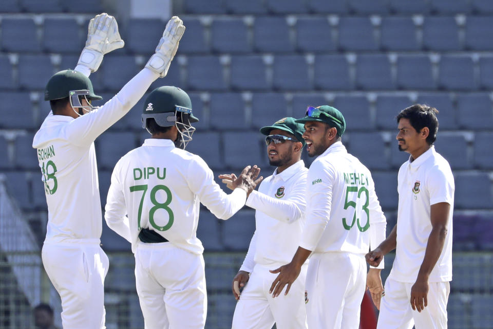 Bangladeshi cricketers celebrate the dismissal of New Zealand's Captain Tim Southee during the fifth day of the first test cricket match at Sylhet, Bangladesh, Saturday, Dec. 2, 2023. (AP Photo/Mosaraf Hossain)