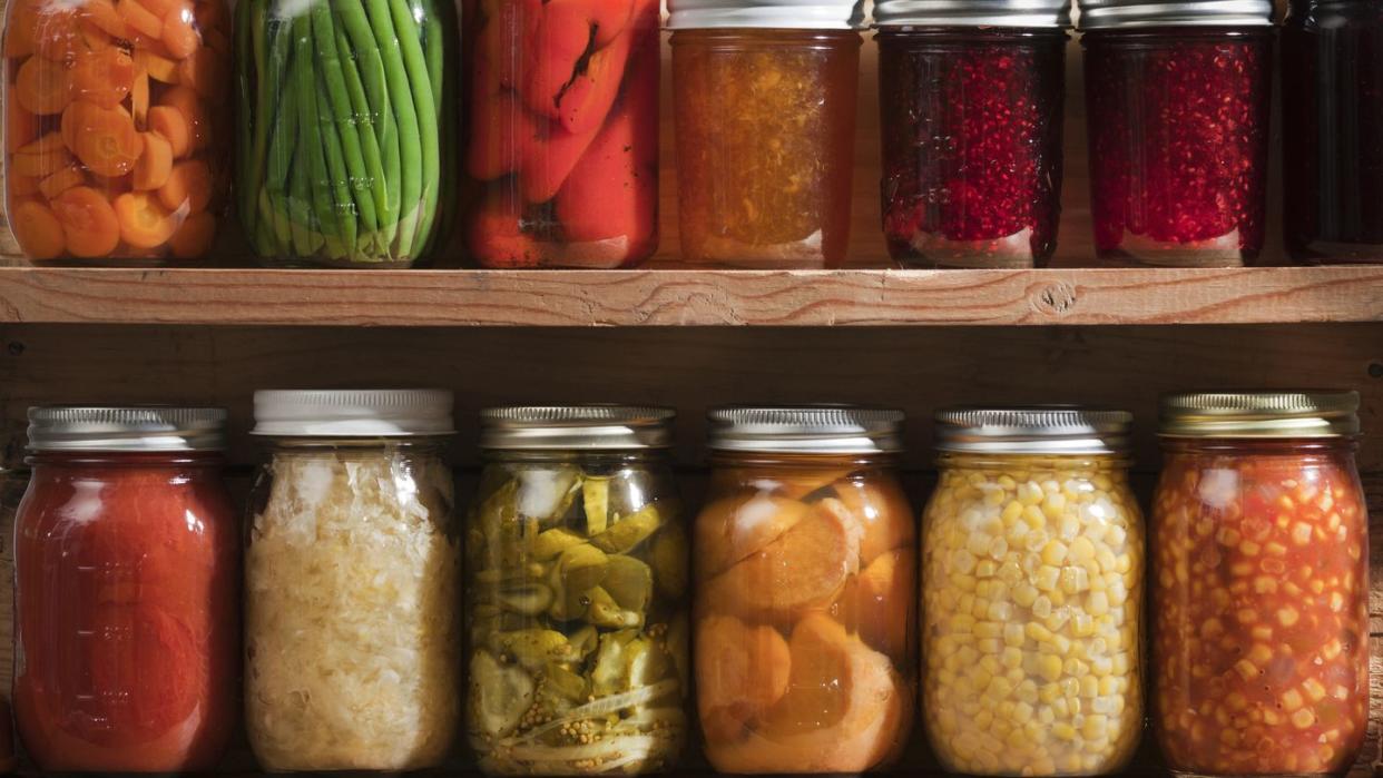home canning, preserving, pickling food stored on wooden storage shelves