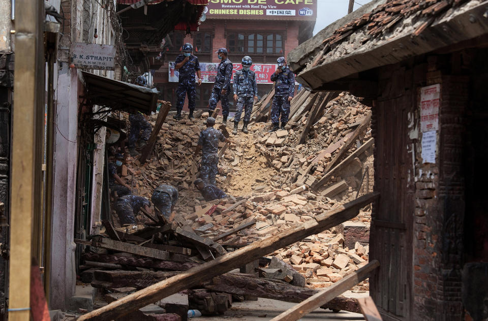 Rescue team members search for bodies in the debris of a collapsed temple at Basantapur Durbar Square on April 27, 2015 in Kathmandu, Nepal. (Photo by Omar Havana/Getty Images)