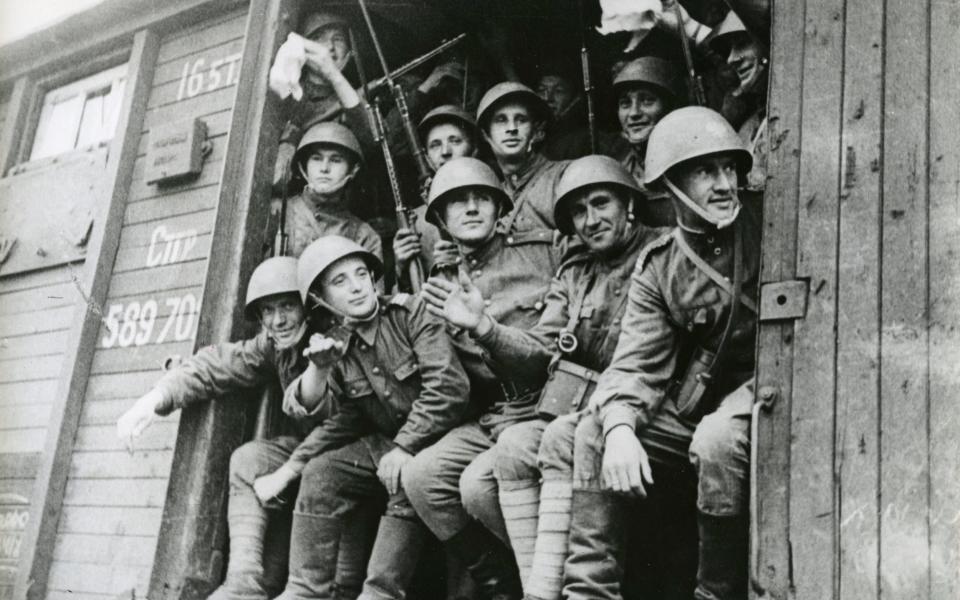 Russian soldiers waving from a train