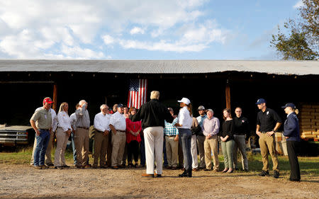 U.S. President Donald Trump and first lady Melania Trump speak with farmers affected by Hurricane Michael in Macon, Georgia, U.S., October 15, 2018. REUTERS/Kevin Lamarque