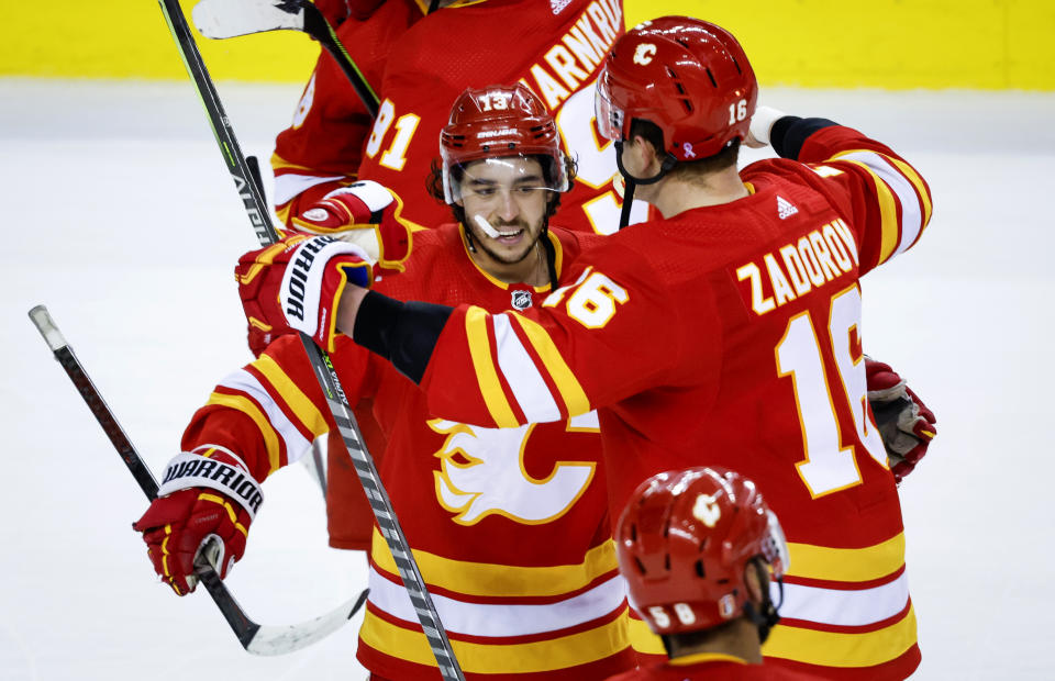 Calgary Flames forward Johnny Gaudreau, left, and defenseman Nikita Zadorov celebrates defeating the Dallas Stars in overtime NHL playoff hockey action in Calgary, Alberta, Sunday, May 15, 2022. (Jeff McIntosh/The Canadian Press via AP)