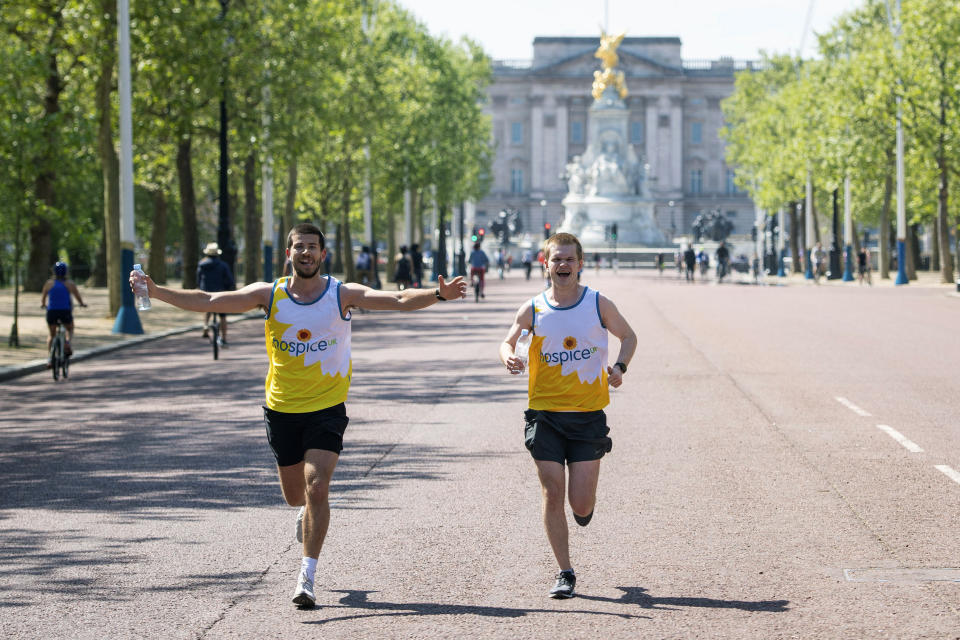 Runners on the Mall at the finish of the London Marathon course, which was postponed to help curb the spread of coronavirus, in London, Sunday April 26, 2020. (Dominic Lipinski/PA via AP)