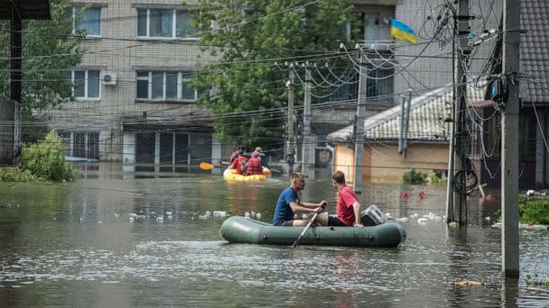 PHOTO: Local residents sail on boats at a flooded street during an evacuation from a flooded area after the Nova Kakhovka dam breached, amid Russia's attack on Ukraine, in Kherson, Ukraine June 8, 2023. (Stringer/Reuters)