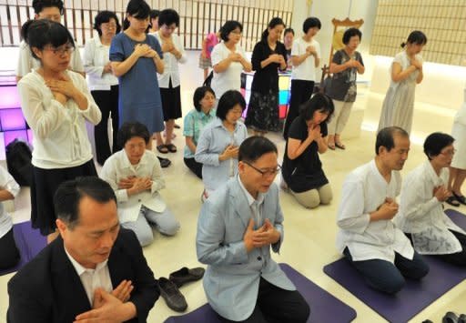 Unification Church followers hold a memorial service mourning the death of their leader Sun Myung Moon in the church's Seoul headquarters on September 3. While it claims a worldwide following of three million, experts suggest the core membership is far smaller