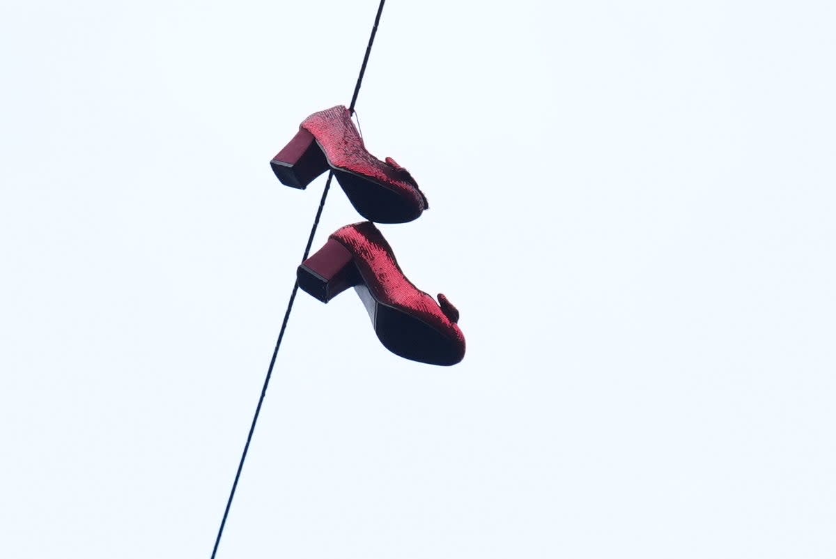 The fictional character can be seen reaching for a pair of shoes hanging from an overhead cable (Jacob King/PA Wire)
