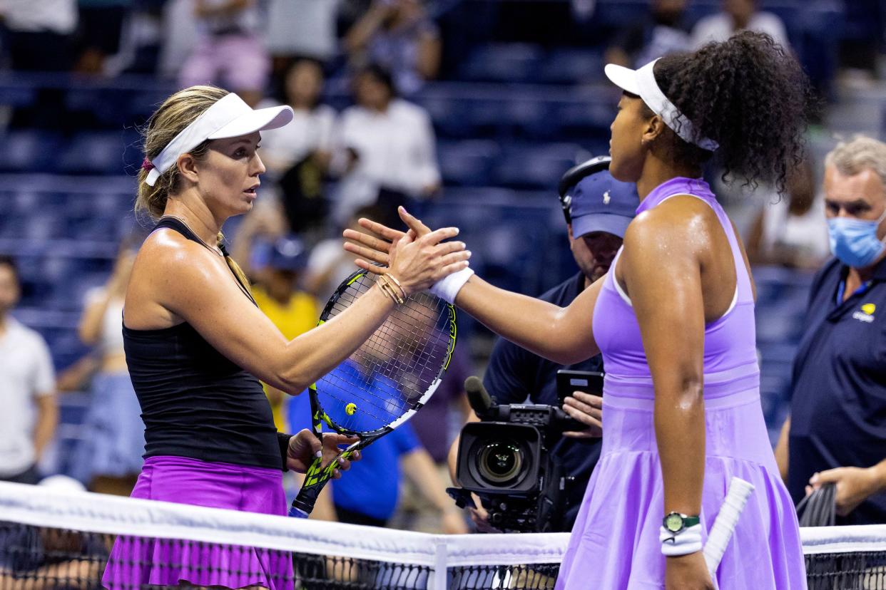 USA's Danielle Collins (L) and Japan's Naomi Osaka (R) greet each other at the net following their 2022 U.S. Open Tennis tournament women's singles first round match at the USTA Billie Jean King National Tennis Center in New York on Aug. 30, 2022.