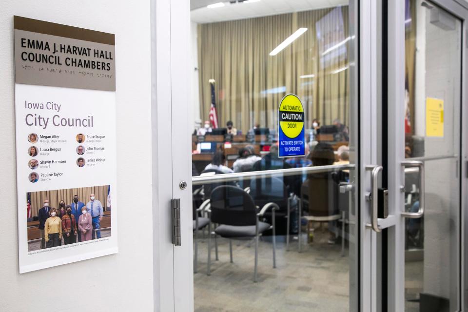 A plaque in the lobby features a photo of the current council members during a council meeting, Tuesday, April 19, 2022, at the Emma J. Harvat Hall inside City Hall in Iowa City, Iowa. They are, from left, back row, councilors John Thomas, Laura Bergus, Bruce Teague, mayor of Iowa City, councilor Shawn Harmsen, front row, Megan Alter, mayor pro tem, councilors Janice Weiner and Pauline Taylor