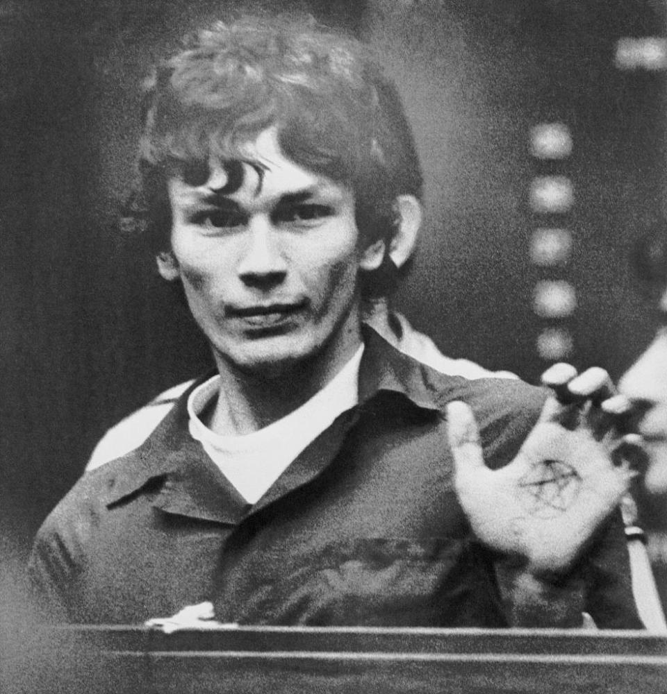 Richard Ramirez showing his pentagram tattoo in open court