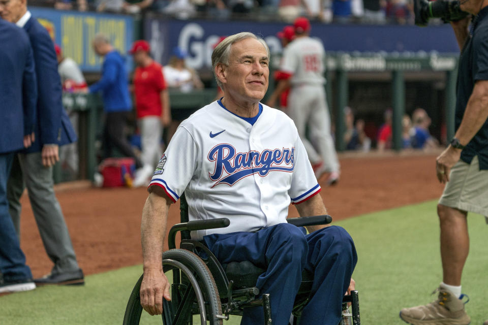 FILE - Texas Gov. Greg Abbott arrives on the field before an opening day baseball game between the Texas Rangers and the Philadelphia Phillies, March 30, 2023, in Arlington, Texas. Texas has been dominated by Republicans for a generation, and state lawmakers and Gov. Greg Abbott this year joined the push from many conservative states to limit LBGTQ+ rights. (AP Photo/Jeffrey McWhorter, File)