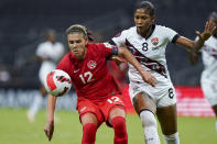 FILE - Canada's Christine Sinclair (12) and Trinidad and Tobago's Victoria Swift compete for the ball during a CONCACAF women's championship soccer match in Monterrey, Mexico, July 5, 2022. (AP Photo/Fernando Llano, File)