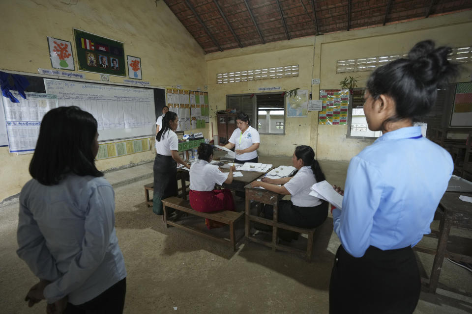 Polling station members count ballots at Toul Snoa primary school outside Phnom Penh, Cambodia, Sunday, July 23, 2023. (AP Photo/Heng Sinith)