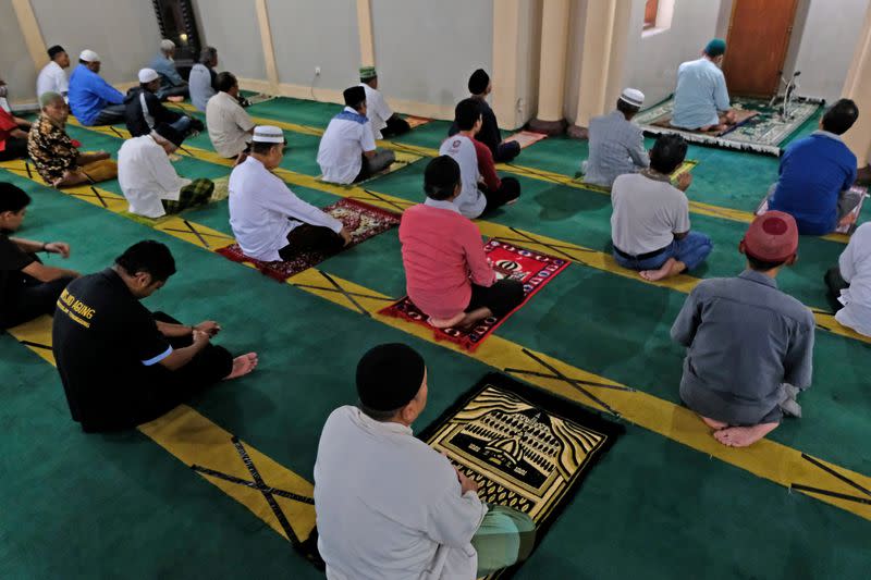FILE PHOTO: Muslims pray while practicing social distancing inside a mosque amid the spread of the coronavirus disease (COVID-19) in Temanggung, Central Java province