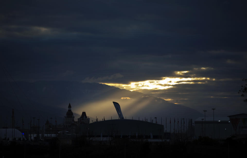 The sun rises over the Olympic cauldron in the Olympic Park at the 2014 Winter Olympics, Wednesday, Feb. 5, 2014, in Sochi, Russia. (AP Photo/David Goldman)