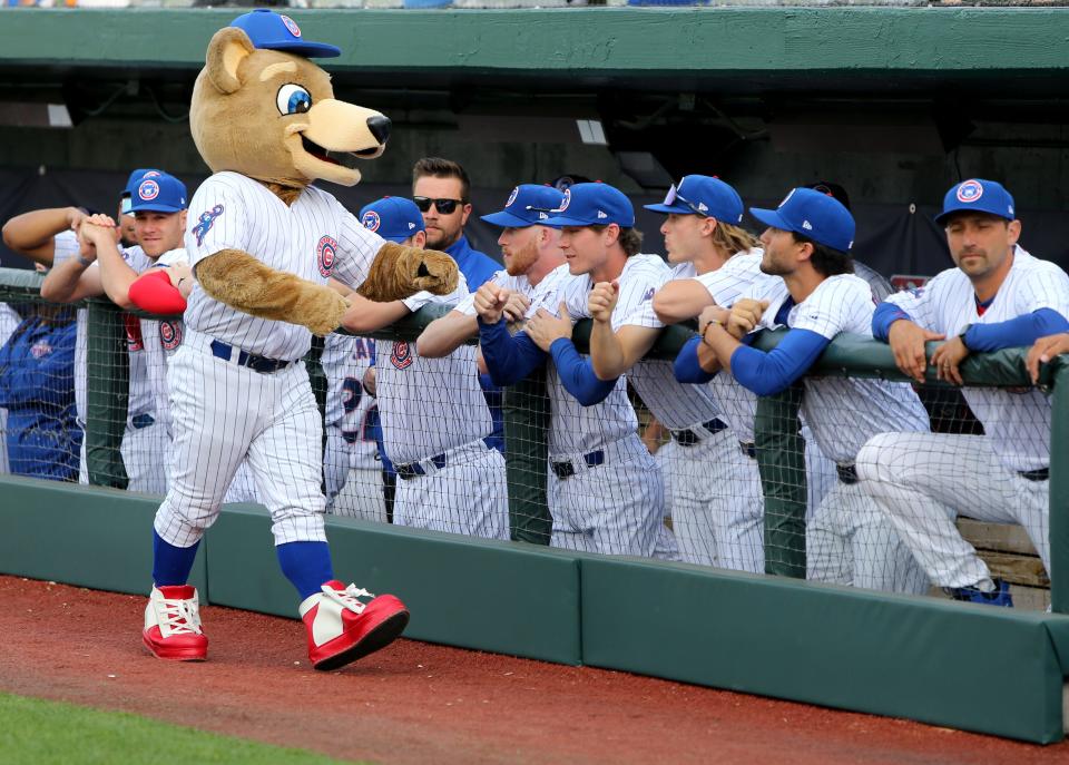 Stu the mascot greets the team in the dugout Tuesday, April 11, 2023, at Four Winds Field for the 2023 season home opening baseball game against Beloit.