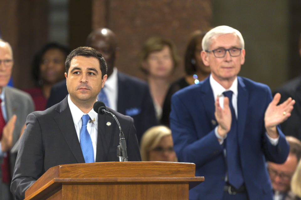 FILE - In this Jan. 7, 2019 file photo, Wisconsin Attorney General Josh Kaul speaks during his address at the inauguration of Gov. Tony Evers, right, at the state Capitol in Madison, Wis. Kaul has filed a motion to withdraw the state from an ongoing federal lawsuit seeking repeal of the Affordable Care Act. Kaul filed the motion Thursday after fellow Democrat, Evers, ordered him to withdraw Wisconsin from the lawsuit. Kaul had been blocked from taking action under a law passed by the Republican Legislature in a lame-duck session shortly before he took office. (AP Photo/Andy Manis, File)