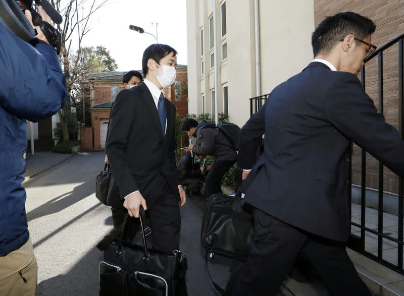 Officials from the Tokyo District Public Prosecutors Office enter the residence of former Nissan chairman Carlos Ghosn in Tokyo