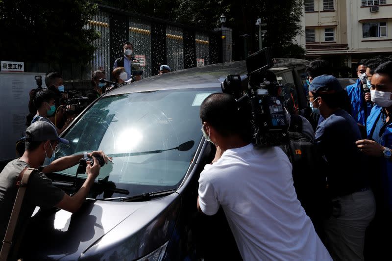 Journalist try to take photo and video of media mogul Jimmy Lai Chee-ying, founder of Apple Daily after he was detained by the national security unit in Hong Kong