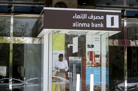 A man leaves an automated teller machine (ATM) outside Alinma Bank in Riyadh, Saudi Arabia, April 25, 2016. REUTERS/Faisal Al Nasser