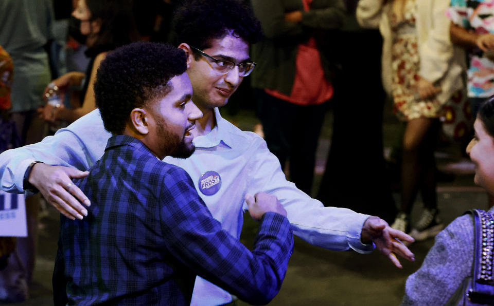 Maxwell Frost, left, a Congressional candidate, greets supporters who have gathered at the Renaissance Theatre Company in Orlando, Fla., on election night, Tuesday, Aug. 23, 2022. Frost, who campaigned on gun control, Medicare for all and criminal justice reform, beat out a crowded cast of Democrats who ran for Florida's 10th Congressional District, an Orlando area seat considered to be a liberal stronghold. (Stephen M. Dowell/Orlando Sentinel via AP)