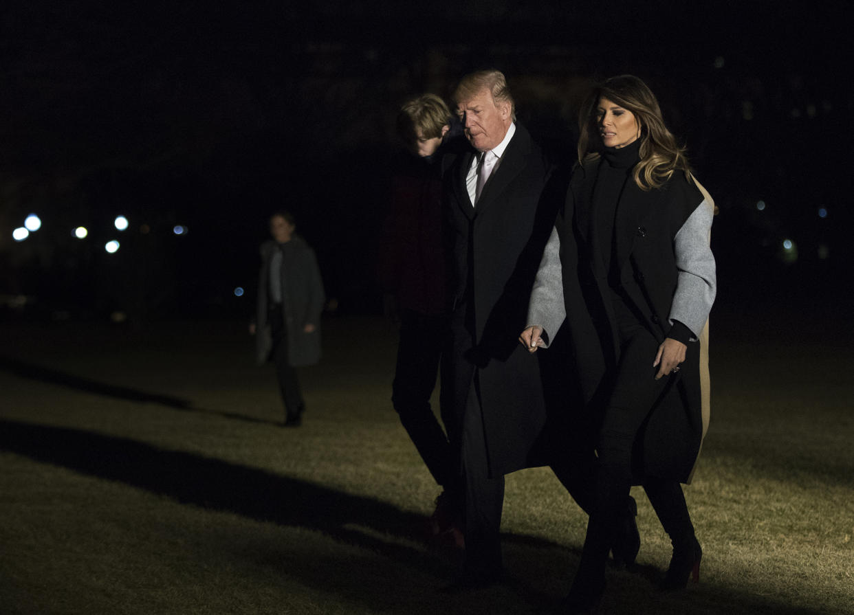 President Donald Trump walks on the South Lawn with first lady Melania Trump and their son Barron Trump upon arrival at the White House in Washington, Monday, Jan. 15, 2018. Trump spent the holiday weekend at his Mar-a-Lago estate in Palm Beach, Fla. (AP Photo/Manuel Balce Ceneta)