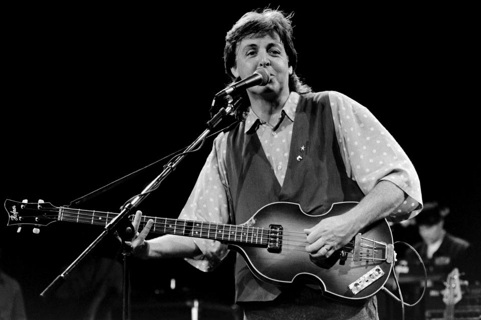 <p>Dave Hogan/Hulton Archive/Getty</p> Paul McCartney playing a different violin bass guitar in 1989