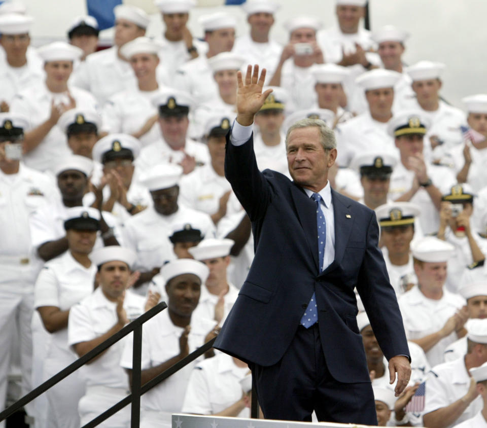 FILE - In this Aug. 30, 2005, photo taken by Associated Press photographer Leonard Ignelzi, President George Bush waves to the crowd after finishing his speech commemorating VJ Day at Naval Station North Island in Coronado, Calif. Ignelzi, whose knack for being in the right place at the right time produced breathtaking images of Hall of Fame sports figures, life along the U.S.-Mexico border, devastating wildfires and numerous other major news events over nearly four decades as a photographer for The Associated Press in San Diego, has died Friday, April 29, 2022. He was 74. (AP Photo/Lenny Ignelzi, File)