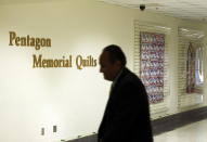 ARLINGTON, VA - JUNE 28: A man passes by the Pentagon Memorial Quilts Corridor where 21 quilts, of more than 100 in the collection that serve as a historical record of the tragic events of 9/11, are on display June 28, 2011 in Arlington, Virginia. This year is the 10th anniversary of the September 11 terrorist attacks, in which 184 people were killed at the Pentagon. (Photo by Alex Wong/Getty Images)