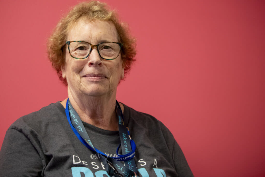 A woman wearing glasses and a T-Shirt.