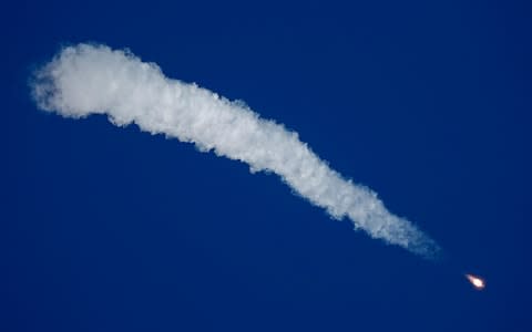 A plume of smoke trails behind the rocket before its crash - Credit: Shamil Zhumatov/Reuters