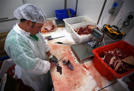 Butcher Trevor Hart cuts up kangaroo meat at a meat packing and distribution warehouse in western Sydney November 6, 2013. REUTERS/David Gray