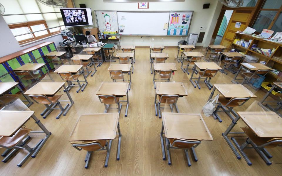 A teacher gives an online class at Neungsil Elementary School in Suwon, South Korea, 12 July 2021, as all schools in Seoul and its neighboring cities went online in accordance with the implementation of Level 4 social distancing the same day amid a fourth wave of COVID-19.  - Shutterstock