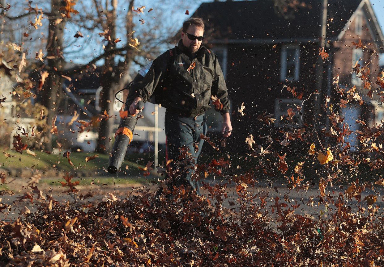 Massillon resident John Gresh blows the leaves out of his yard at his southwest side home Tuesday, November 23rd, 2021. 